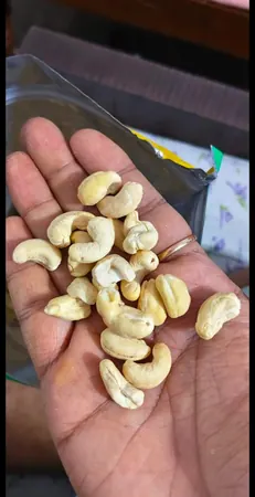 Customer photo: cashews in a hand beside an opened pack